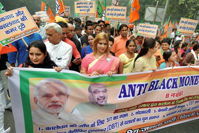 Latest news on policy | The WhatsApp Governance | ThePrint BJP workers display a banner during their Anti-black Money Day rally to mark the first anniversary of 'Demonetisation' announcement in New Delhi on Wednesday.