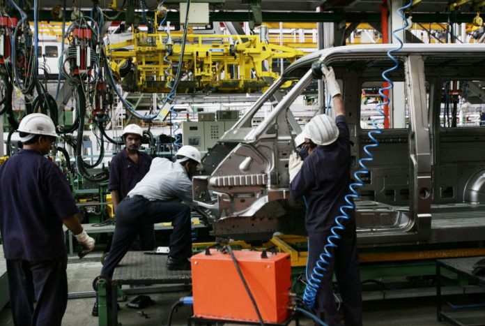 Latest news on NCAER mid year review | theprint.in Workers in a car factory
