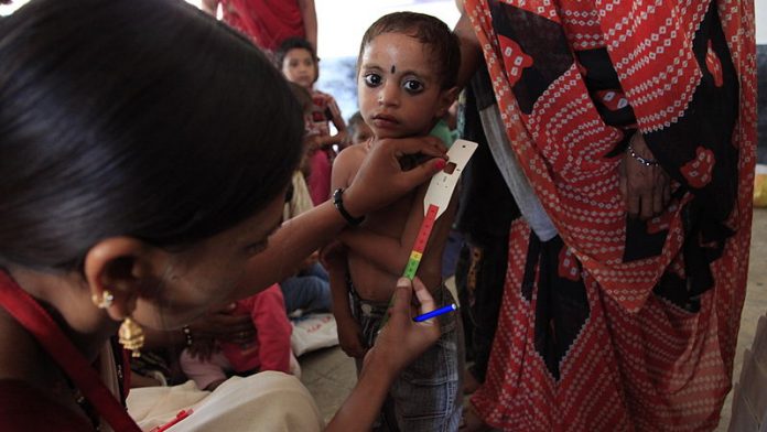 Mother and child measuring malnutrition