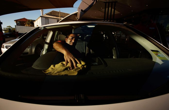 Latest news on Uber and Ola on New Years' Eve| theprint.in Man cleaning his car