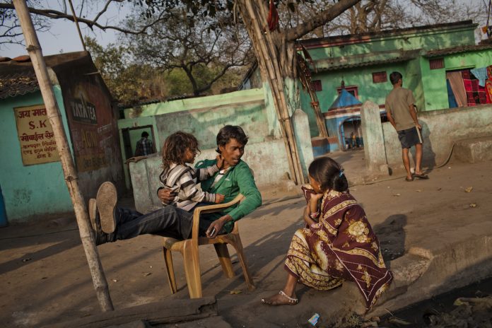 Coal Mining In India's Jharia A villager sits with his family in the village of Guhanwadi near Jharia in Jharkhand