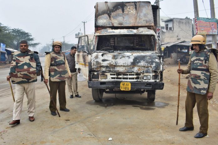 Latest news on policy | Faith in ML Khattar rock bottom| ThePrint Police personnel inspect a burnt truck