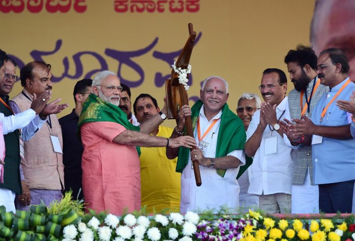 Latest news on Karnataka elections| Theprint.in Prime Minister Narendra Modi hands over a model of polugh to Karnataka BJP President and chief ministerial candidate B S Yeddyurappa during the party's 'Farmers Convention' at Davanagere