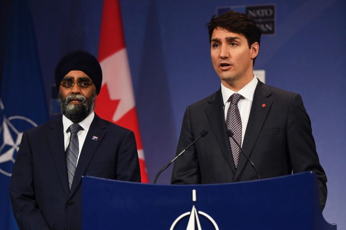 Latest news on Canadian Prime Minister Justin Trudeau flanked by Canadian Minister of Defence Harjit Sajjan