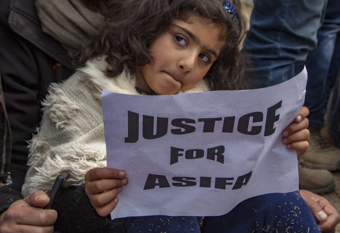 Latest news on 8-year-old's murder and religious divide| Theprint.in A child holds a placard as she takes part in a protest demanding the death penalty for the suspects in the rape and murder of an eight-year-old girl | Yawar Nazir/Getty Images