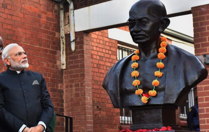 Latest news on Mahatma Gandhi Narendra Modi with a statue of Mahatma Gandhi