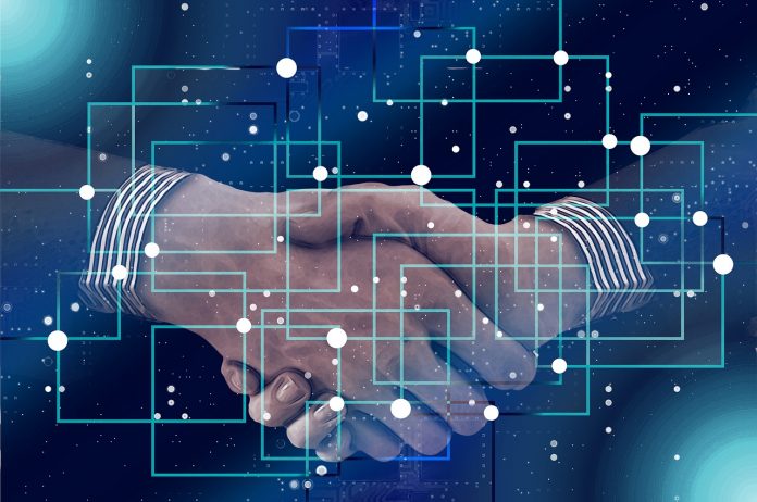 Latest news on blockchain technology | theprint.in Two interconnected hands and grid-lines. Representational image.