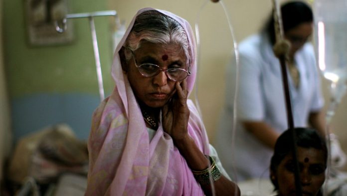 Latest news on monkey fever | ThePrint.in A woman looks on over her husband's sick bed in a local hospital.