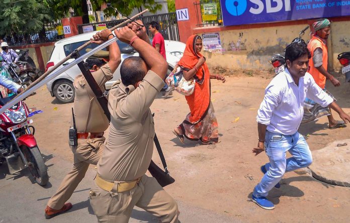 Latest news on Dalit atrocities | theprint.in Police personnel lathicharge on an activist during the 'Bharat Bandh' by Dalit organisations, in Varanasi Monday. | PTI