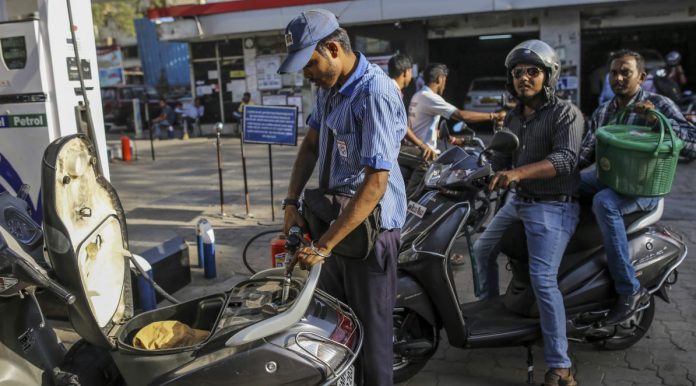 Latest news on oil price hike | ThePrint.in A worker refuels a scooter | Dhiraj Singh/Bloomberg