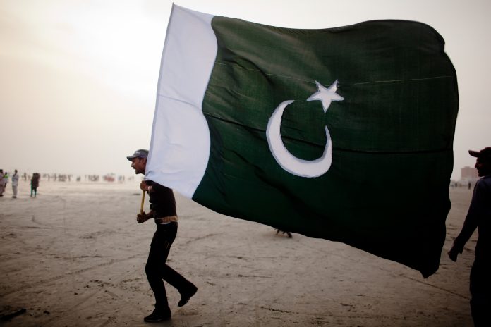 Latest news on Pakistan | theprint.in A man walks with a Pakistan National flag | Daniel Berehulak/Getty Images