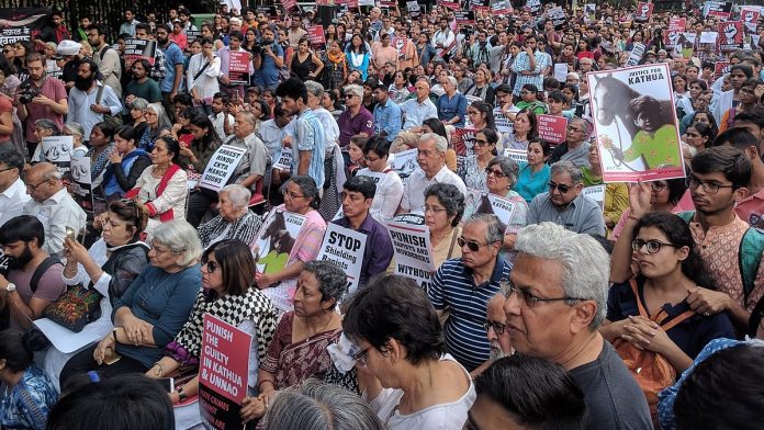 People take part in a protest against Kathua and Unnao rape cases