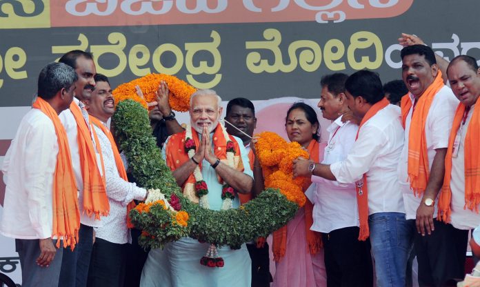 Latest news on BJP | ThePrint PM Narendra Modi being garlanded by BJP workers at an election campaign rally | PTI