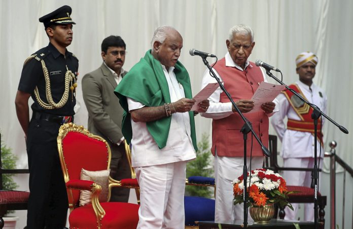 Yeddyurappa sworn-in as K'taka CM Karnataka Governor Vajubhai Vala administers oath to BJP leader B. S. Yeddyurappa as Chief Minister of the state at a ceremony in Bengaluru