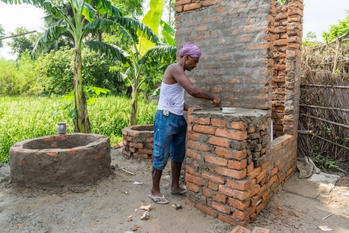 Latest news on Swachh Bharat | ThePrint Man constructing toilet in a village in Muzaffarnagar, Bihar | Christopher Wilton-Steer/Aga Khan Development Network