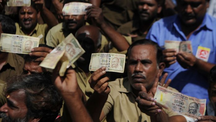 Latest news on Demonetisation | ThePrint Indian trade union members pose for media holding banned currency notes during a demonstration against demonitisation in Chennai | Arun Sankar/AFP/Getty Images