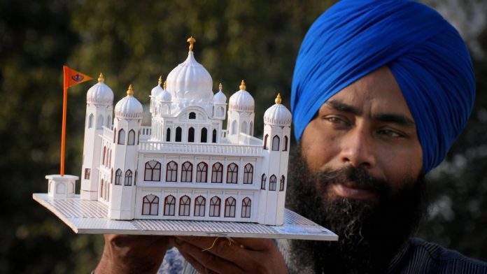 Kartarpur Sahib paper model Artist Gurpreet Singh shows his paper model of Kartarpur Sahib gurdwara | PTI