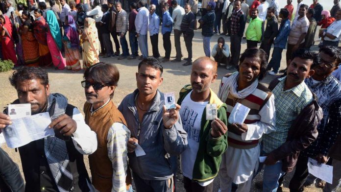 Latest news on Madhya Pradesh polls | ThePrint People wait with their identity cards to cast their votes for the Assembly elections, in Jabalpur, Madhya Pradesh