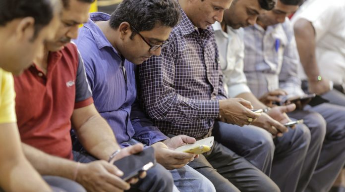 Latest news on smatphones and fake news | theprint.in Passengers use smartphones at Mumbai Central railway station | Dhiraj Singh/Bloomberg