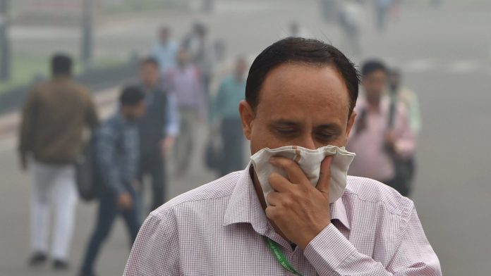 Latest news on Delhi air pollution | ThePrint A pedestrian covers his face with a handkerchief for protection against air pollution in New Delhi | Shahbaz Khan/PTI