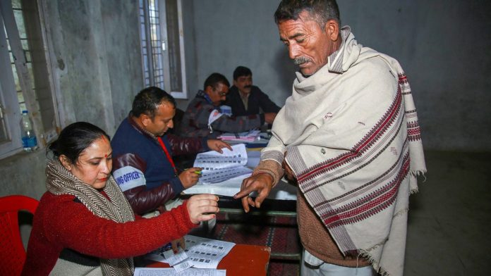 Latest news on Assembly elections | ThePrint An election officer put an indelible ink mark on the finger of a voter | PTI