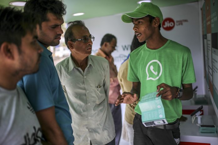 Latest news on WhatsApp Facebook and Reliance Jio are teaming up to draw hordes of customers with cheap phones, rock-bottom rates and handy messaging services. Dhiraj Singh/Bloomberg