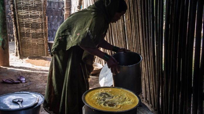 Latest news on ICDS | ThePrint An anganwadi worker cooks for children under the ICDS scheme | Sanjit Das/Bloomberg