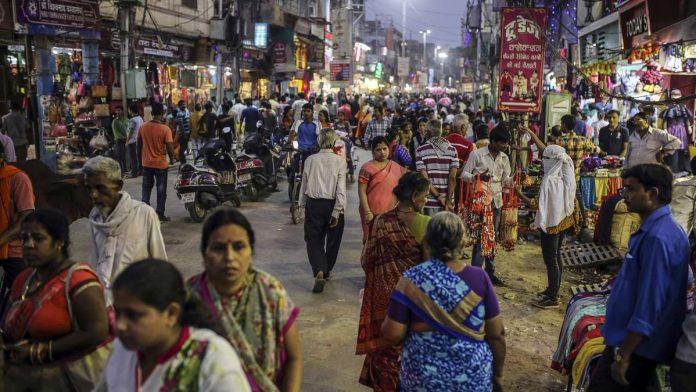 Latest news on Economy | ThePrint Pedestrians and shoppers walk past stores on a street in Varanasi (representational image)