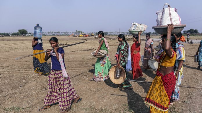 One Man's Plan to Build Singapore in India Sends Land Soaring Workers carry equipment and supplies in Andhra Pradesh| Representational image | Dhiraj Singh/Bloomberg