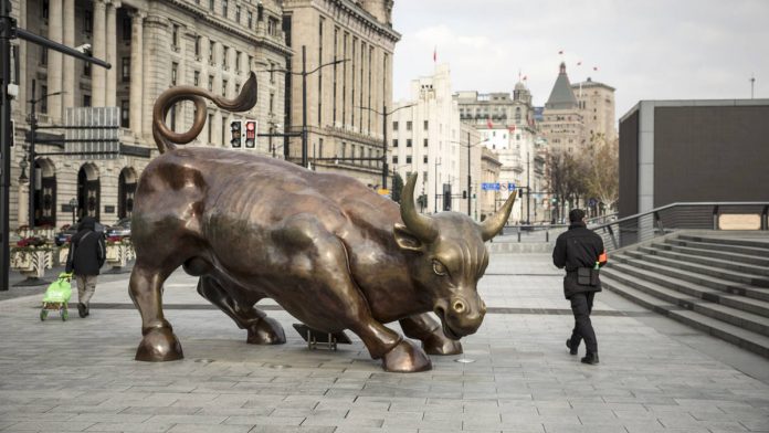 Latest news on China | ThePrint Pedestrians walk past the Bund Bull statue in Shanghai