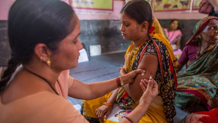 Latest news on Health| ThePrint A health worker immunises a pregnant woman at a health centre in Aurangabad, India