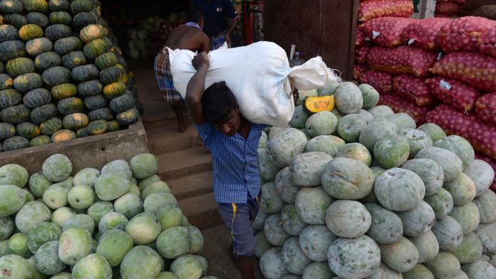 Latest news on Indian economy | ThePrint.in An vendor carries a sack of pumpkins at a wholesale market in Chennai