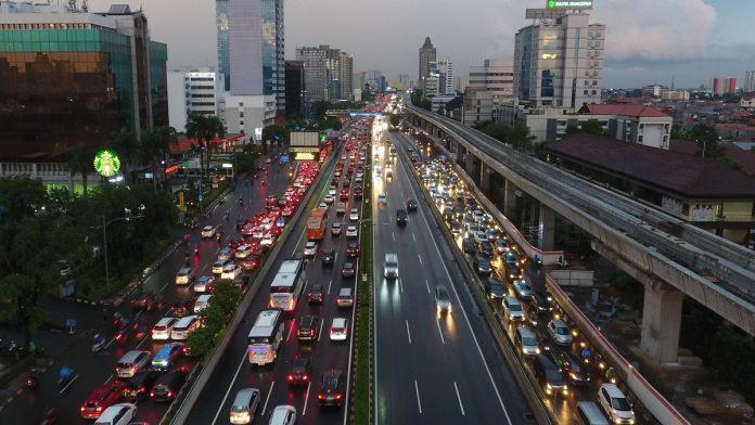 Latest news on Indonesia | ThePrint.in Vehicles travel along a road as an elevated track for the Jakarta Mass Rapid Transit (MRT) rail system, right, stands under construction at dusk in Jakarta, Indonesia