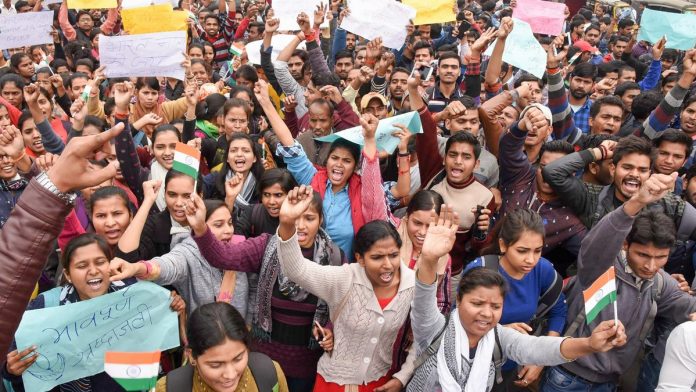 Protestors raise slogans during a demonstration against the Pulwama terror attack
