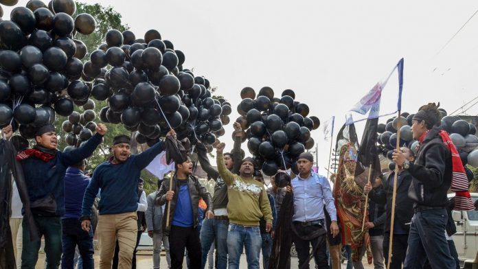 Latest news on Assam | ThePrint.in AASU memebrs display black ballons on Prime Minister Narendra Modi's arrival in Dibrugarh |PTI