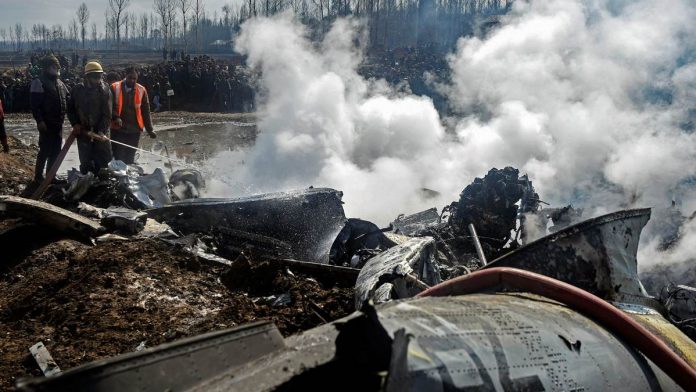 Fire fighters douse flames at the site where an MI-17 chopper of the IAF crashed in Budgam