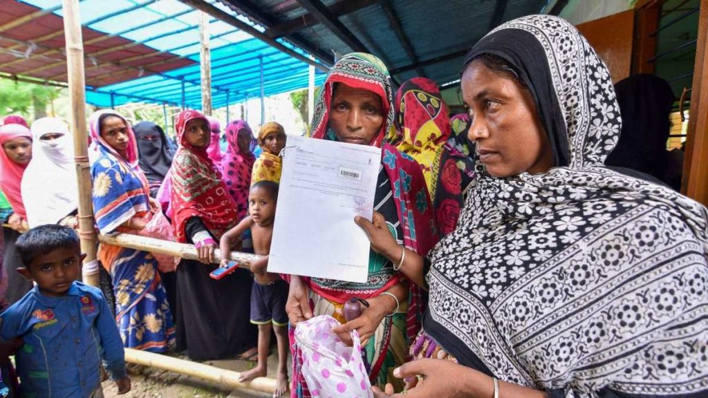 People queue up to check their names on the final draft of the NRC in Assam