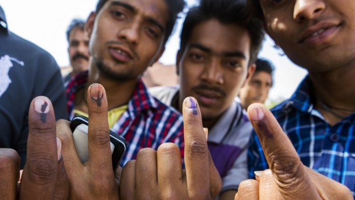 Latest news on elections| ThePrint.in Voters displays their inked fingers for a photograph after casting their votes at a polling station in New Delhi, India, on April 10, 2014|