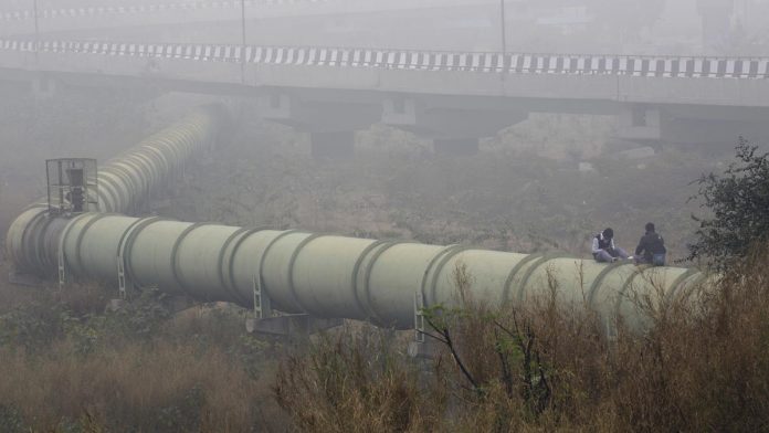 Latest news on water pollution | ThePrint Men sit on water pipeline in Delhi (Representational image)