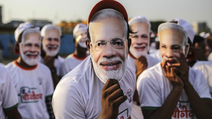 Latest news on Narendra Modi | theprint.in Supporters of PM Narendra Modi wear his masks, Mumbai | Dhiraj Singh | Bloomberg