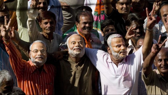 Latest news on 2019 Lok Sabha elections | theprint.in Supporters of BJP wearing masks of Narendra Modi | Sanjit Das/Bloomberg News