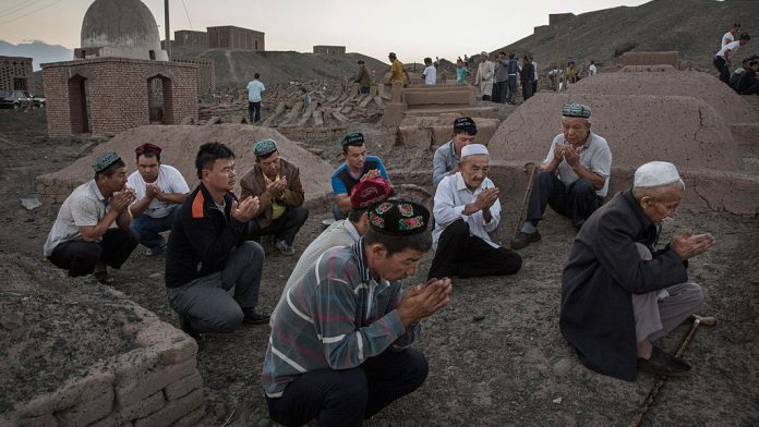 China's Uyghur Minority Marks Muslim Holiday In Country's Far West Uyghur men perform prayers for ancestors at a cemetery before the Corban Festival