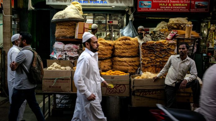 Ramadan Spending Ahead OF CPI Figures Pedestrians walk past stalls selling food outside the Jama Masjid | Sanjit Das | Bloomberg