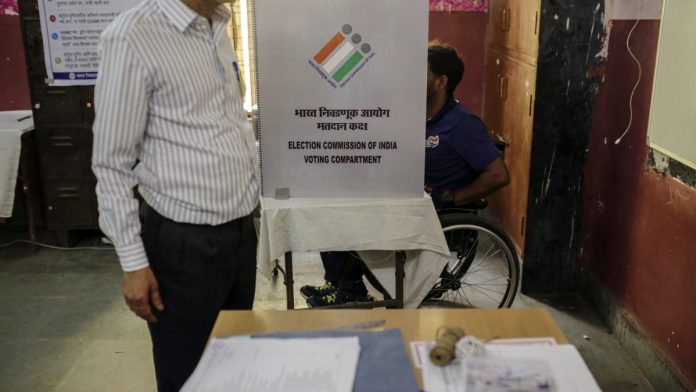 India's Financial Capital Goes To The Polls A voter in a wheelchair casts his ballot at a polling station in Mumbai | Dhiraj Singh/Bloomberg