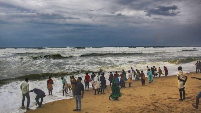Cyclone 'Fani' Villagers at the beach as dark clouds hover above the sea ahead of cyclone 'Fani'