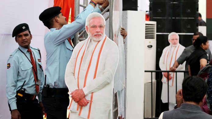 Indian Prime Minister Narendra Modi Release the BJP Party's Election Manifesto Cardboard cut-outs of Modi are displayed at an even