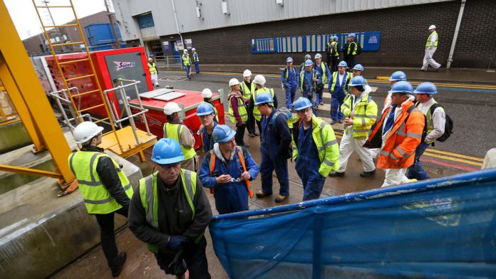 Latest Developments On British Navy Aircraft Carriers Being Built By The Aircraft Carrier Alliance Workers at a busy shipping yard