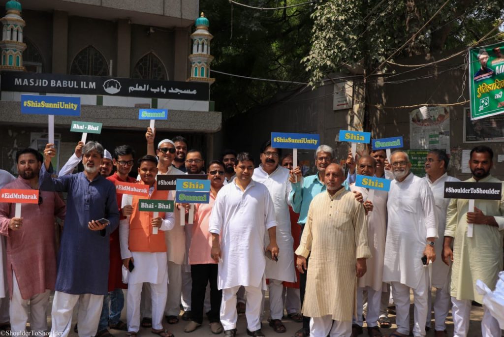 Shia and Sunni Muslims hold placards with the message of promoting unity in their communities | By special arrangement