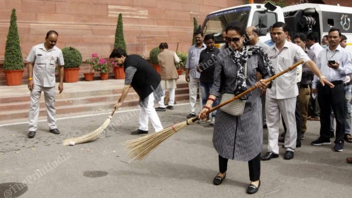   MPs Hema Malini (right) and MoS Anurag Thakur were seen sweeping the premises of Parliament 
