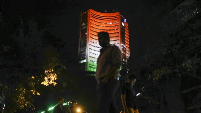 Investors Chasing Higher Returns Can't Skip India, Manulife Says Pedestrians walk past the Bombay Stock Exchange (BSE) building